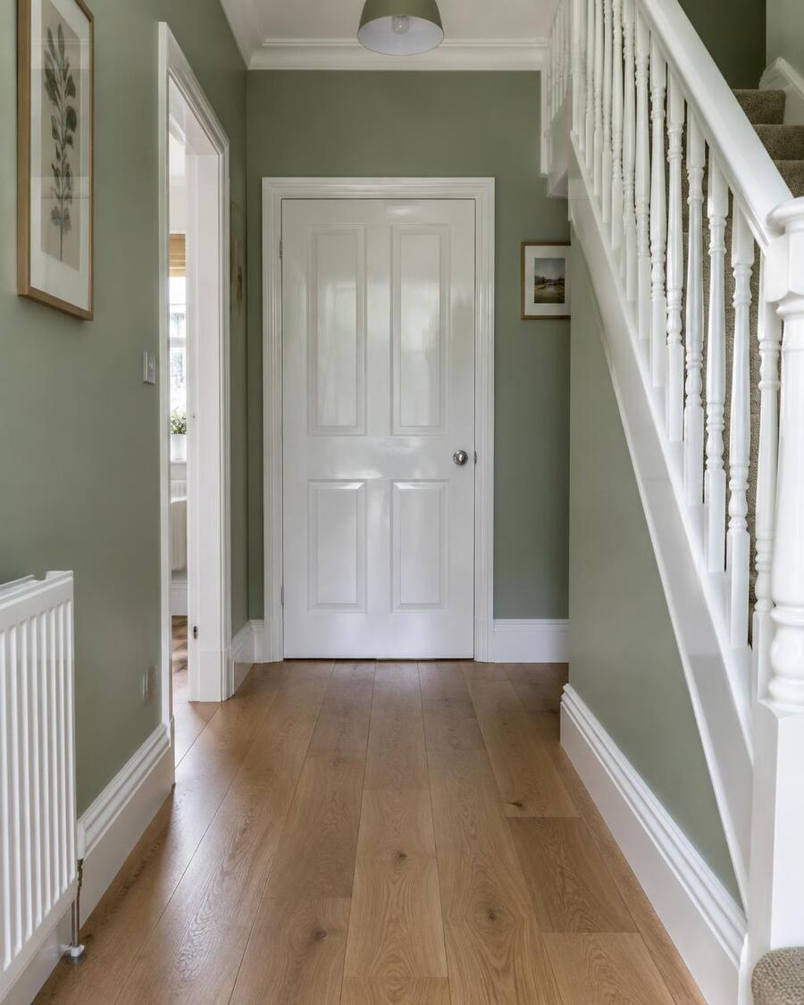 Hallway with sage green walls and freshly painted white woodwork (illustrative image)